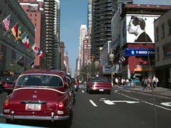 Lucy, Desi, and Steve Jobs thinking Different with two Saab 96 V-4s on Third Avenue in Manhattan.