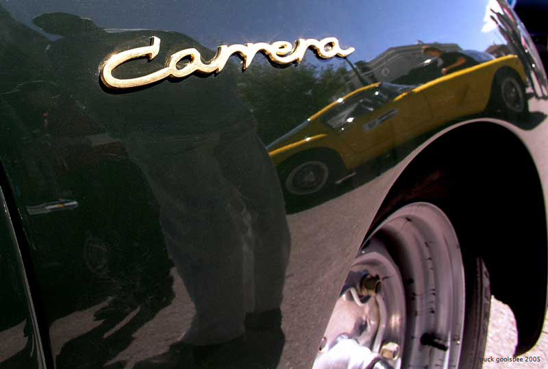  yellow Ferrari 250 SWB reflected in the fender of a Porsche 356 Carrera